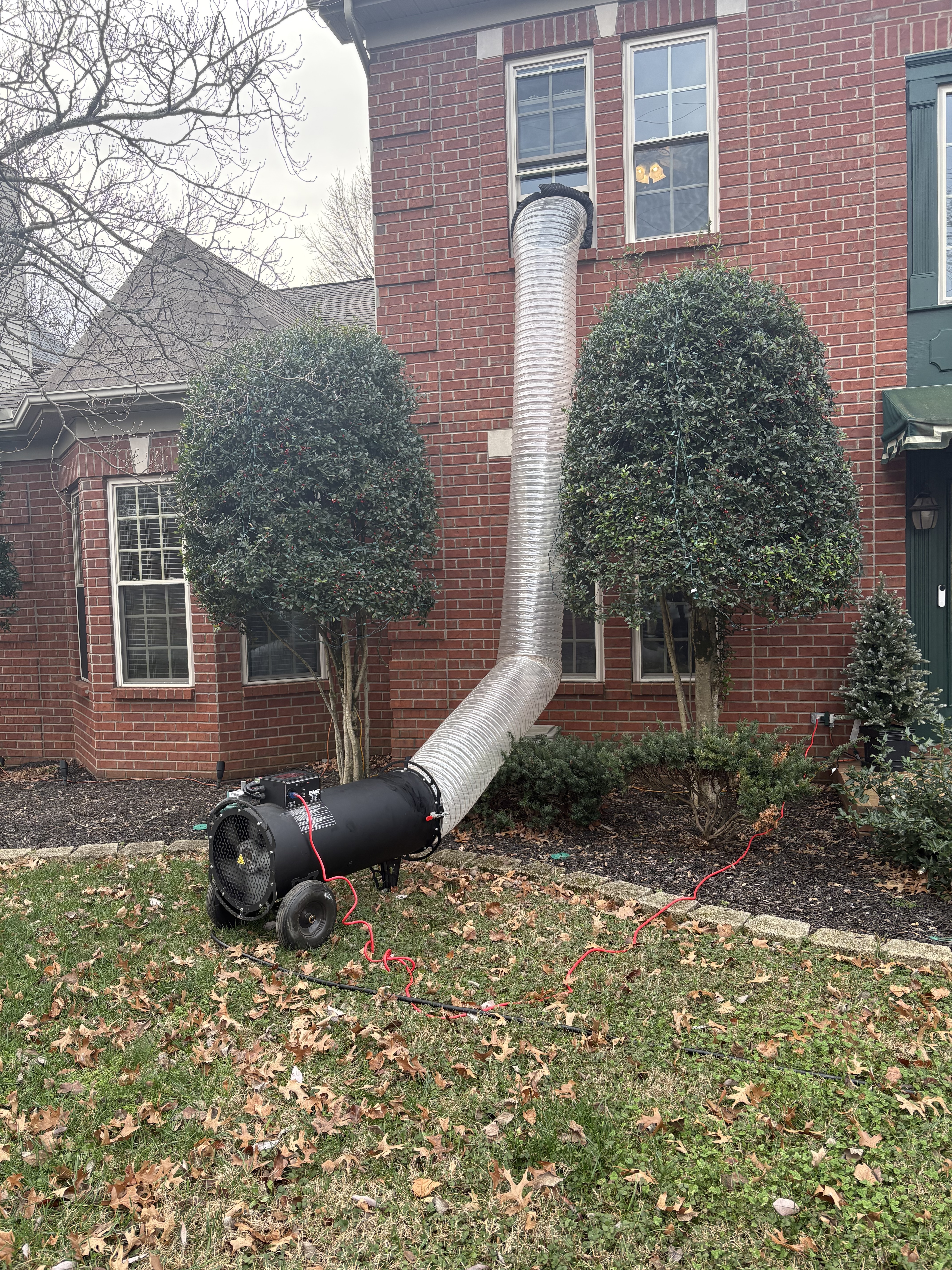 Mylar Duct routed into a second-story brick building window.