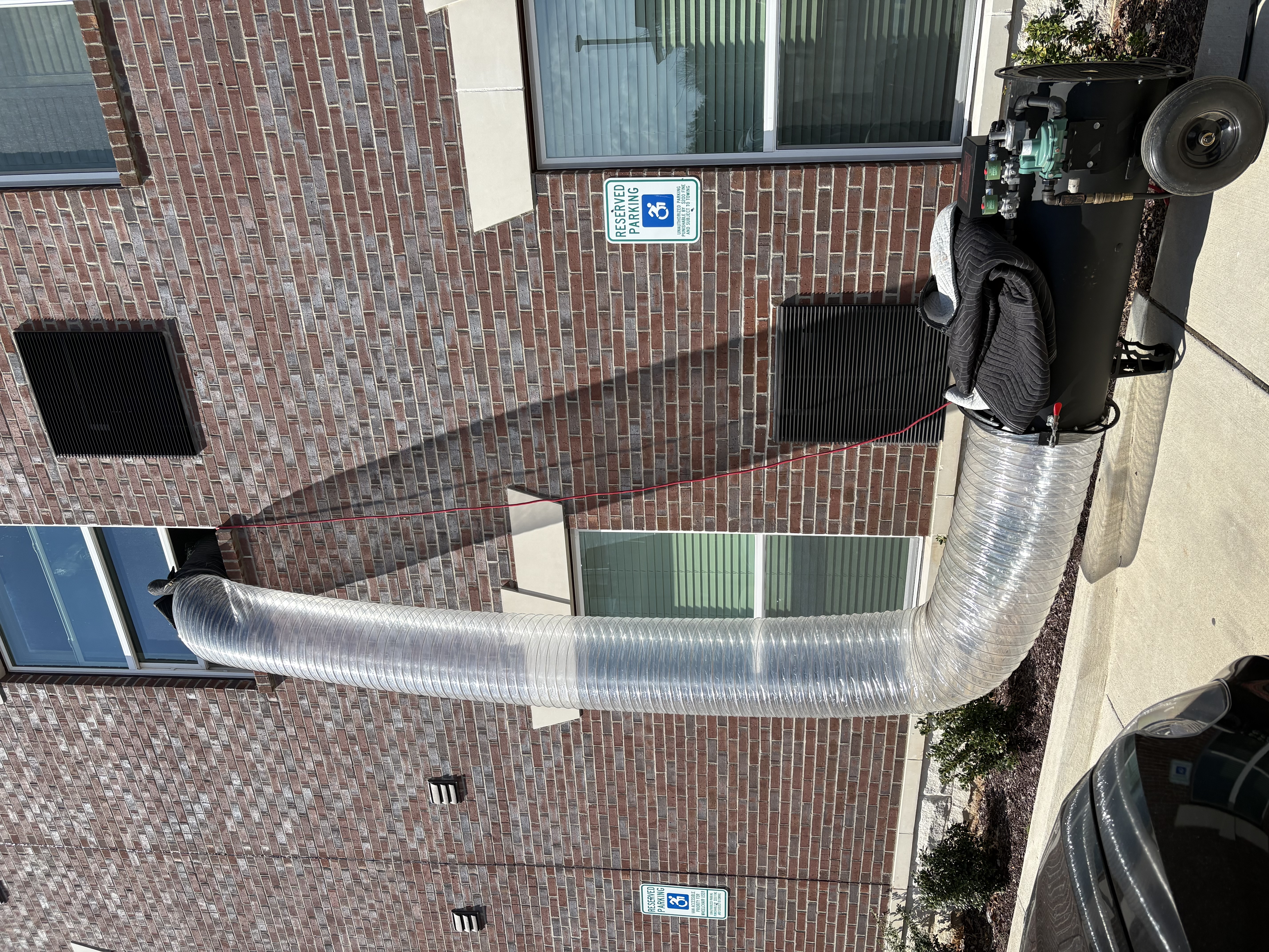 Mylar Duct routed from a heater into a brick building window.